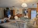 Kitchen features light cabinets, pendant lighting, tile floors and opens up to the living room at 3311 Papaya Rd, Venice, FL 34293