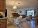 Kitchen and living room with tile floors, abundant light, and wood furnishings at 3311 Papaya Rd, Venice, FL 34293