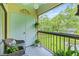 Relaxing balcony with patterned tile, comfortable seating, and a serene view of lush greenery at 3382 Mermoor Dr # 3201, Palm Harbor, FL 34685