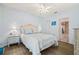 Charming bedroom with hardwood floors, a ceiling fan, and an attached bathroom entrance at 3382 Mermoor Dr # 3201, Palm Harbor, FL 34685