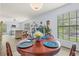 Cozy dining room featuring a round table with four chairs and a large window for natural light at 3382 Mermoor Dr # 3201, Palm Harbor, FL 34685