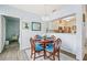 Bright dining area with a round table, elegant chandelier, and view to kitchen at 3382 Mermoor Dr # 3201, Palm Harbor, FL 34685