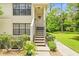 Front entrance of a lovely townhome with a welcoming wreath and well-manicured landscaping at 3382 Mermoor Dr # 3201, Palm Harbor, FL 34685