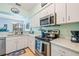 Modern kitchen featuring stainless steel appliances, white cabinets, and stylish countertops at 3382 Mermoor Dr # 3201, Palm Harbor, FL 34685