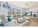 Bright and airy living room featuring comfortable seating, wood flooring, and an abundance of natural light at 3382 Mermoor Dr # 3201, Palm Harbor, FL 34685