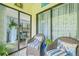 Relaxing patio with wicker chairs, decorative pillows, and a view of lush greenery at 3382 Mermoor Dr # 3201, Palm Harbor, FL 34685