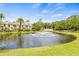 Scenic view of a well-maintained pond with a fountain, enhancing the community's appeal at 3382 Mermoor Dr # 3201, Palm Harbor, FL 34685