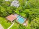Aerial shot of a community pool with a screened enclosure, offering a refreshing escape at 3382 Mermoor Dr # 3201, Palm Harbor, FL 34685