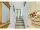 Inviting entryway with wood stairs, decor, and a 'Home Sweet Home' door hanging at 3382 Mermoor Dr # 3201, Palm Harbor, FL 34685