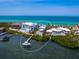 Panoramic aerial shot of a luxury waterfront home with a private boat dock and expansive views of the intercostal waterway at 3516 Casey Key Rd, Nokomis, FL 34275