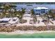 Stunning aerial view of a beachfront home, featuring direct beach access and nestled between other luxury residences at 3516 Casey Key Rd, Nokomis, FL 34275