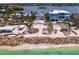 Beautiful aerial view of a beachfront home, featuring direct beach access and nestled between other luxury residences at 3516 Casey Key Rd, Nokomis, FL 34275