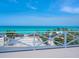 White deck railing overlooking a white sandy beach at 3516 Casey Key Rd, Nokomis, FL 34275