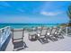 Rooftop deck with lounge chairs and ocean views at 3516 Casey Key Rd, Nokomis, FL 34275
