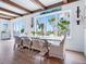 Elegant dining room with large windows, hardwood floors, and stylish decor at 3516 Casey Key Rd, Nokomis, FL 34275