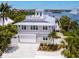 Stunning waterfront home features a rooftop terrace, spacious garage, and lush landscaping at 3516 Casey Key Rd, Nokomis, FL 34275