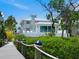 Beautiful home featuring backyard pool, hot tub, lounge area, and waterfront views from multiple vantage points at 3516 Casey Key Rd, Nokomis, FL 34275