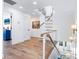 Bright hallway with wood flooring, white walls, and a modern spiral staircase, leading up to the second level at 3516 Casey Key Rd, Nokomis, FL 34275