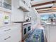 Chef's kitchen with stainless steel range, white cabinetry, and stylish blue rug at 3516 Casey Key Rd, Nokomis, FL 34275