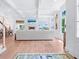 Spacious living room with white walls, coffered ceilings, fireplace, and light-colored wood flooring at 3516 Casey Key Rd, Nokomis, FL 34275