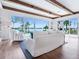 Bright living room with wooden beam ceiling, hardwood floors, and waterfront views at 3516 Casey Key Rd, Nokomis, FL 34275