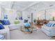Inviting living room features a modern sofa, textured rug, coffered ceiling, and a glass top coffee table at 3516 Casey Key Rd, Nokomis, FL 34275