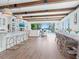 Open-concept living space with modern kitchen, dining area, and comfortable seating at 3516 Casey Key Rd, Nokomis, FL 34275