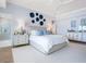 Bright, tastefully decorated main bedroom featuring coastal blues and luxury details at 3516 Casey Key Rd, Nokomis, FL 34275