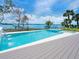 Inviting swimming pool with spa, water features, and beautiful waterfront views at 3516 Casey Key Rd, Nokomis, FL 34275