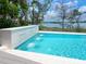 Enjoy this backyard pool with a modern waterfall feature and relaxing waterfront views at 3516 Casey Key Rd, Nokomis, FL 34275