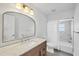 Bathroom with a large mirror, vanity, toilet, and tiled shower-tub combination at 381 La Playa Ln, Port Charlotte, FL 33953
