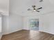 Bright bedroom featuring wood-look floors, ceiling fan and a sliding glass door at 381 La Playa Ln, Port Charlotte, FL 33953