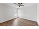 Bright bedroom with a fan, a window with blinds and wood-look flooring at 381 La Playa Ln, Port Charlotte, FL 33953