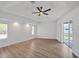 Primary bedroom boasts wood-look floors, recessed lighting, and a large sliding glass door at 381 La Playa Ln, Port Charlotte, FL 33953
