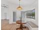 Breakfast nook with a bay window and built-in bench seating next to a wood table under pendant lighting at 381 La Playa Ln, Port Charlotte, FL 33953