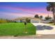 Charming single-story home featuring a manicured lawn and a pristine driveway leading to an attached two-car garage at 381 La Playa Ln, Port Charlotte, FL 33953