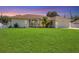 Charming single-story home featuring a manicured lawn and a pristine driveway leading to an attached two-car garage at 381 La Playa Ln, Port Charlotte, FL 33953