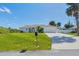 Charming single-story home featuring a manicured lawn and a pristine driveway leading to an attached two-car garage at 381 La Playa Ln, Port Charlotte, FL 33953