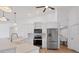 Open kitchen featuring white cabinets, stainless steel appliances, quartz countertops and wood-look flooring at 381 La Playa Ln, Port Charlotte, FL 33953