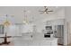 Bright open kitchen boasts quartz counters, stainless appliances, pendant lighting, and ample cabinet space at 381 La Playa Ln, Port Charlotte, FL 33953