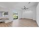 Open living room area boasts recessed lights, sliding glass door, and wood look flooring at 381 La Playa Ln, Port Charlotte, FL 33953