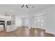 An open floor plan features a kitchen with stainless appliances, ceiling fans, and elegant flooring throughout at 381 La Playa Ln, Port Charlotte, FL 33953