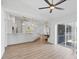Open concept with wood-look floors leads to the kitchen and a large sliding glass door at 381 La Playa Ln, Port Charlotte, FL 33953