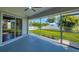 Covered and screened lanai featuring patio, yard, fence and greenery at 381 La Playa Ln, Port Charlotte, FL 33953