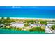 Beautiful aerial view overlooking a public beach access road, parking lot, and a pristine sandy beach at 3950 Pepper Ln, North Port, FL 34287