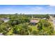 Aerial view showcasing a pool home surrounded by lush greenery and mature trees, offering privacy and tranquility at 3950 Pepper Ln, North Port, FL 34287
