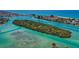 Incredible aerial view showcasing island with lush greenery, and beautiful turquoise waters at 3950 Pepper Ln, North Port, FL 34287