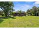 Expansive backyard features a screened lanai and pool, surrounded by palm trees at 3950 Pepper Ln, North Port, FL 34287