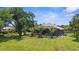 Expansive backyard features a screened lanai and pool, surrounded by tropical landscaping at 3950 Pepper Ln, North Port, FL 34287