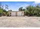 Exterior view featuring a large garage with two doors and ample parking space, perfect for storage or workshop at 3950 Pepper Ln, North Port, FL 34287